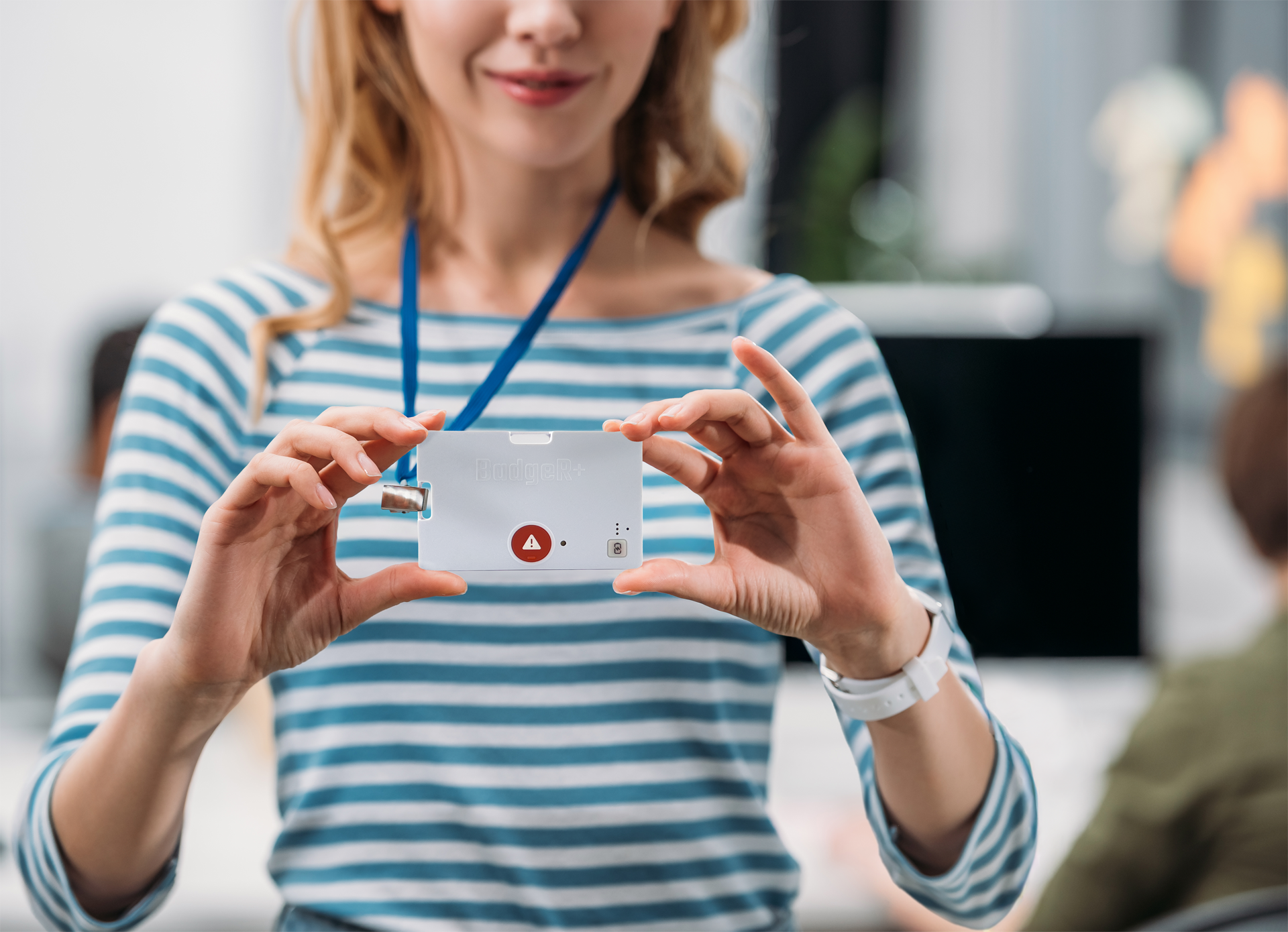 BadgeR+ - Woman in Blue and White Stripe Holding it Up on Lanyard - Mockup