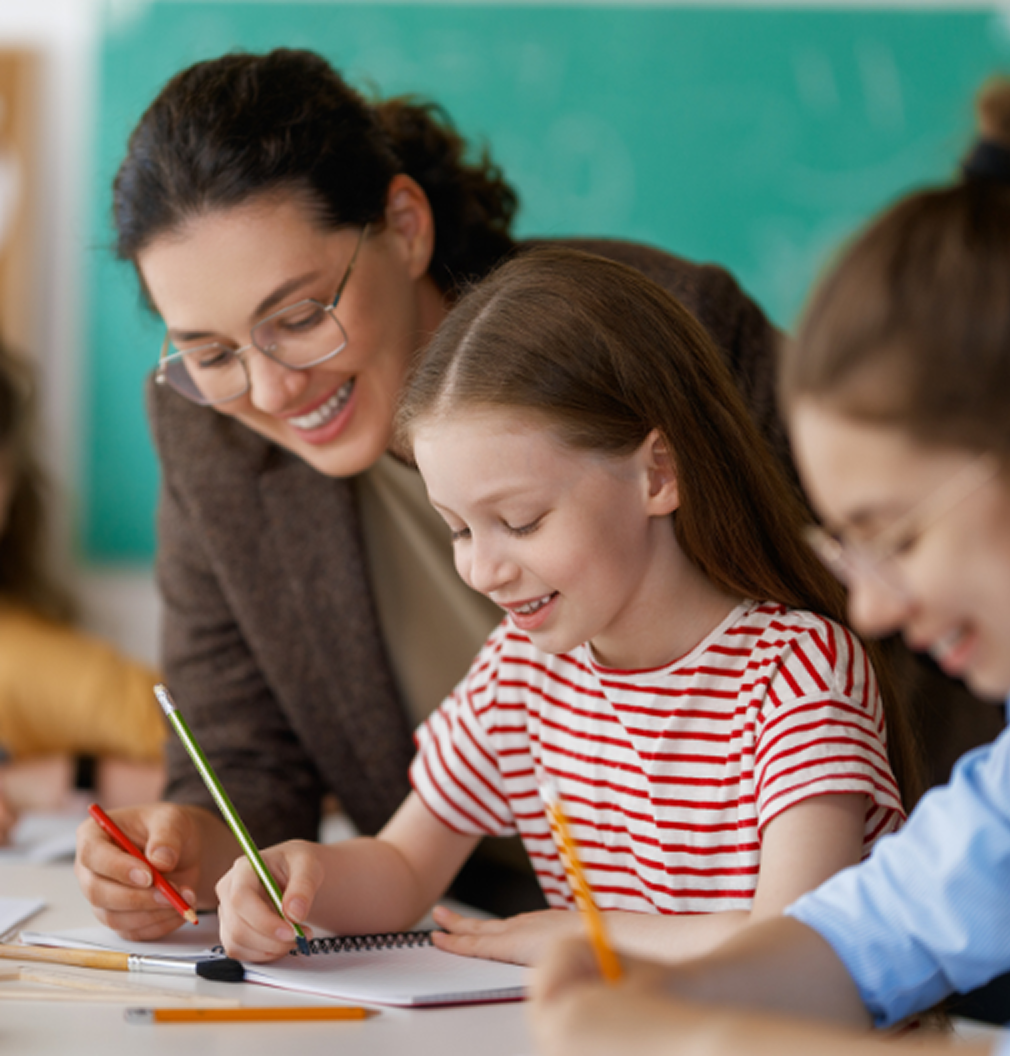 Female Teacher Helping Two Students