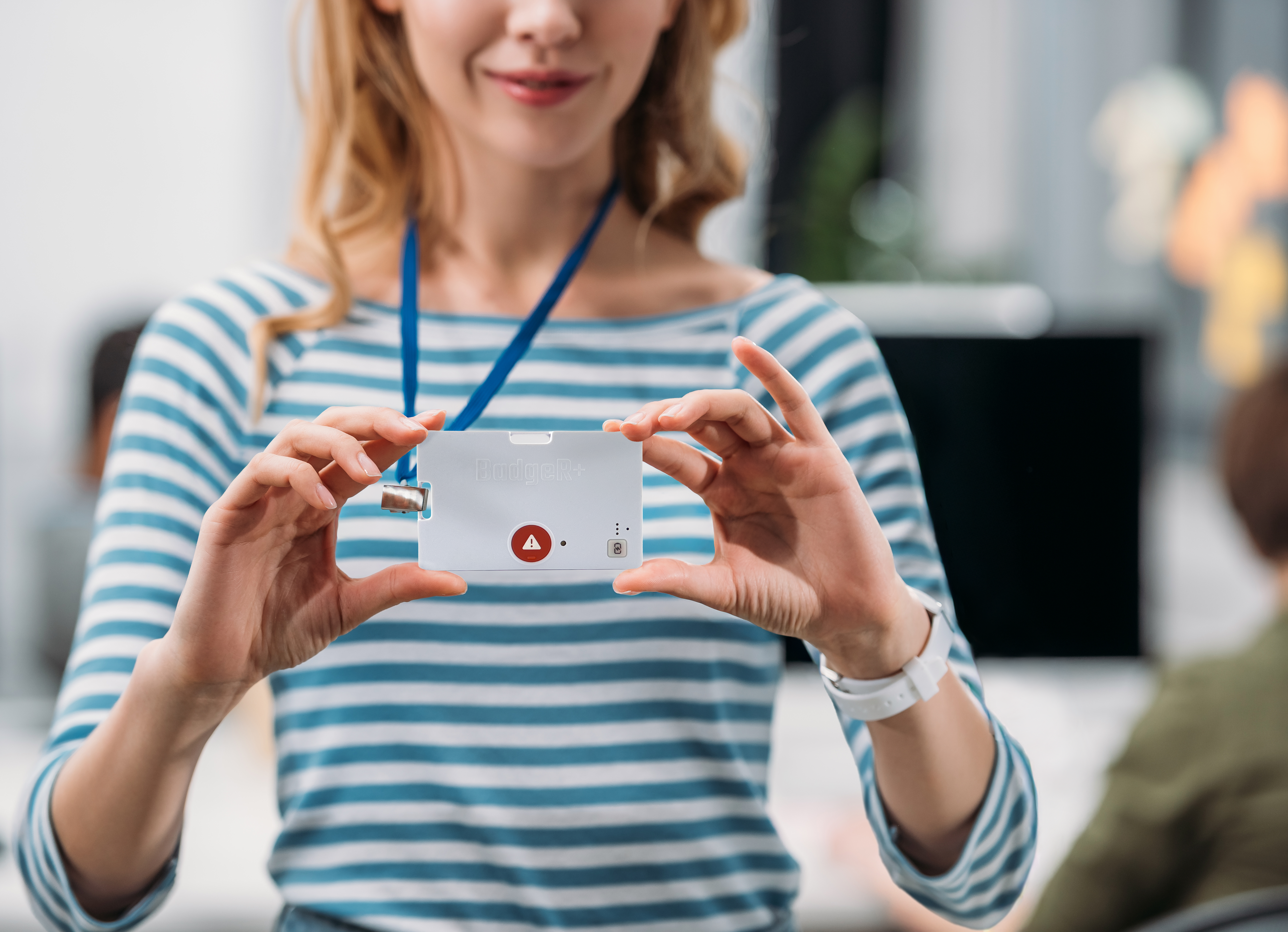 BadgeR+ - Woman in Blue and White Stripe Holding it Up on Lanyard - Mockup