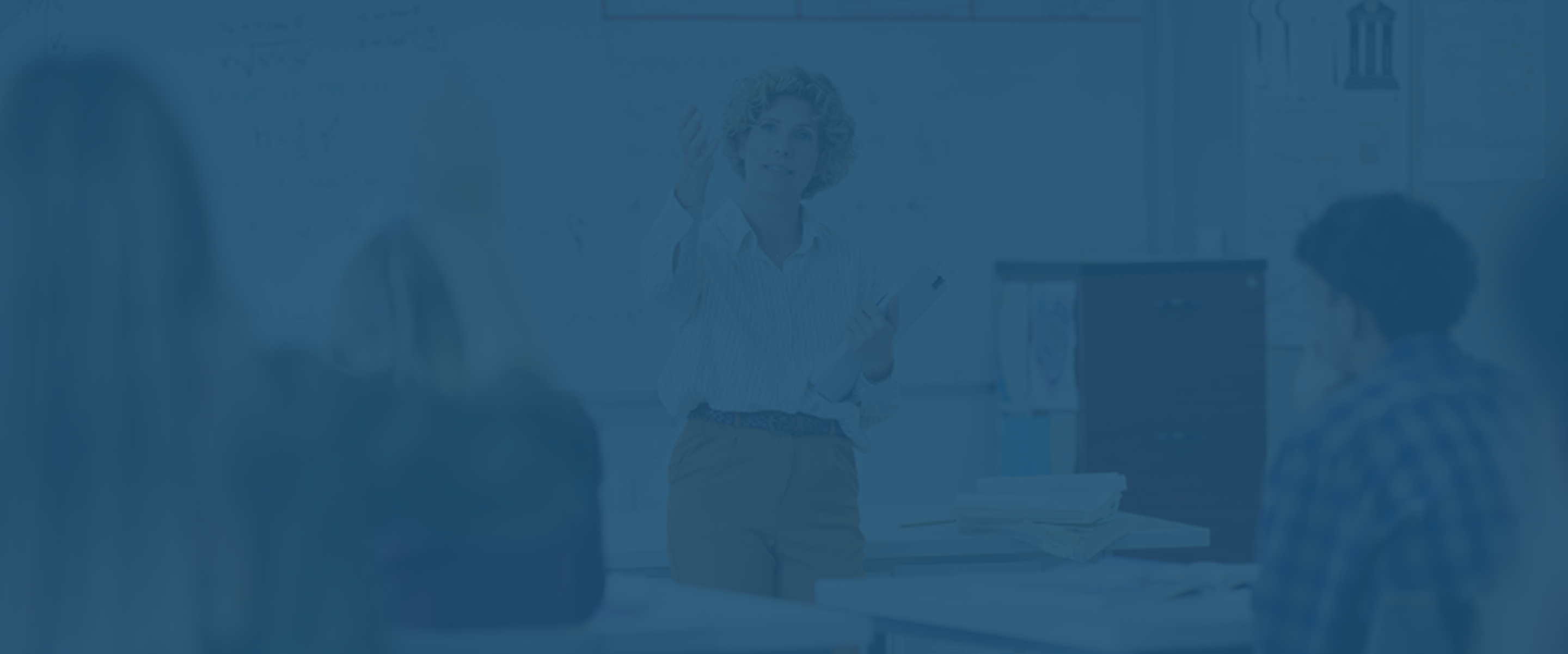 K-12 teacher at the front of the classroom